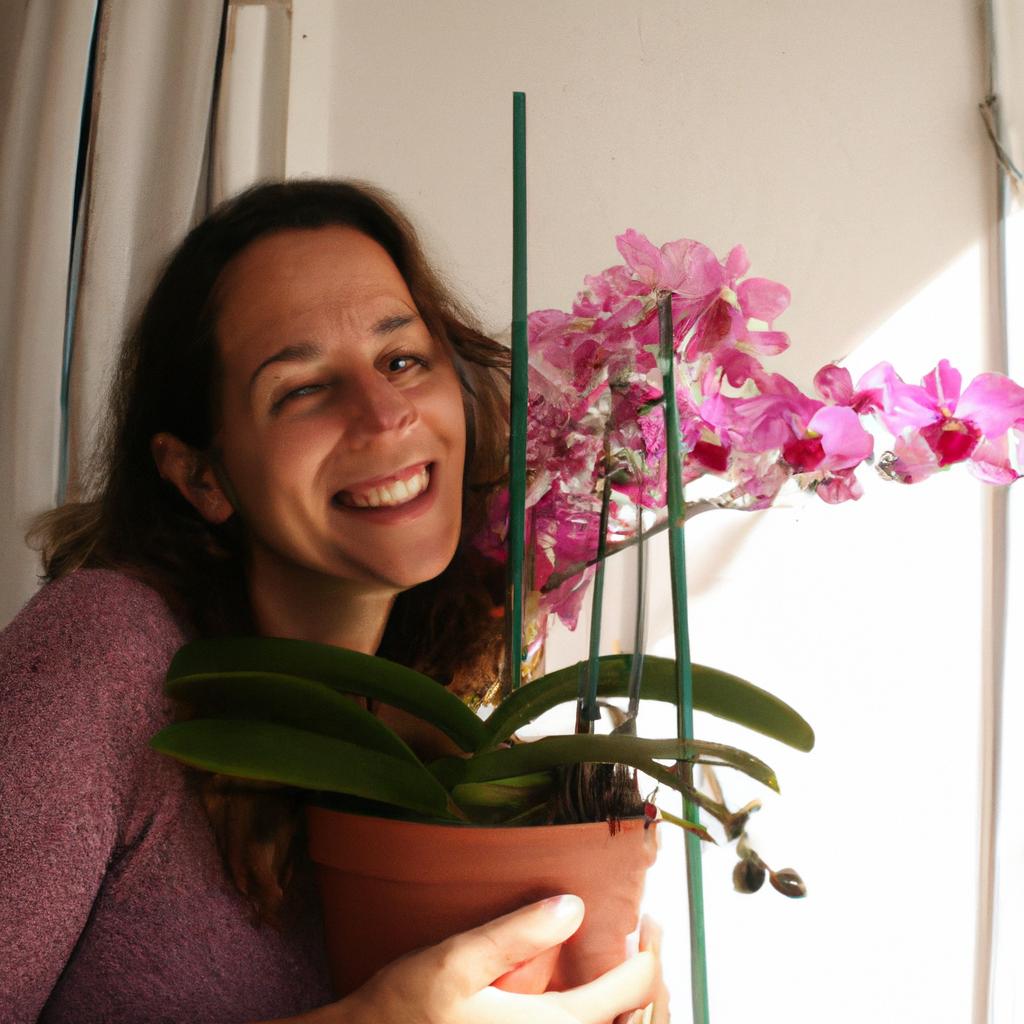 Person holding potted orchids, smiling